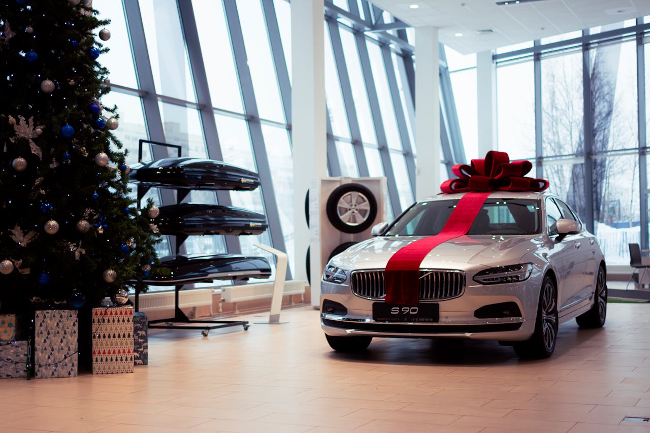 Volvo S90 in showroom decorated with a Christmas tree and gift ribbon for the festive season.